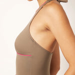 Ikonō La Versatile one-piece swimwear in Tierra. This high-quality, eco-friendly swimsuit is designed for comfort and support, featuring a soft lining and sculpting effect. Perfect for all body types, including post-surgery and mastectomy needs. A stylish, inclusive swimwear option. #BeWhatMovesYou