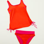 Flat lay of the orange Ikonō tankini and matching high-waist bottom, featuring adjustable drawstring detail for a customizable fit and comfort.