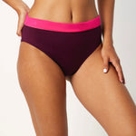 Ikonō La Versatile bikini swimsuit in Aubergine with high-waisted, foldable bottom. Designed for comfort and support, made from eco-friendly materials. Perfect for all body types, including post-surgery swimwear needs. A stylish and inclusive swimwear choice. #BeWhatMovesYou