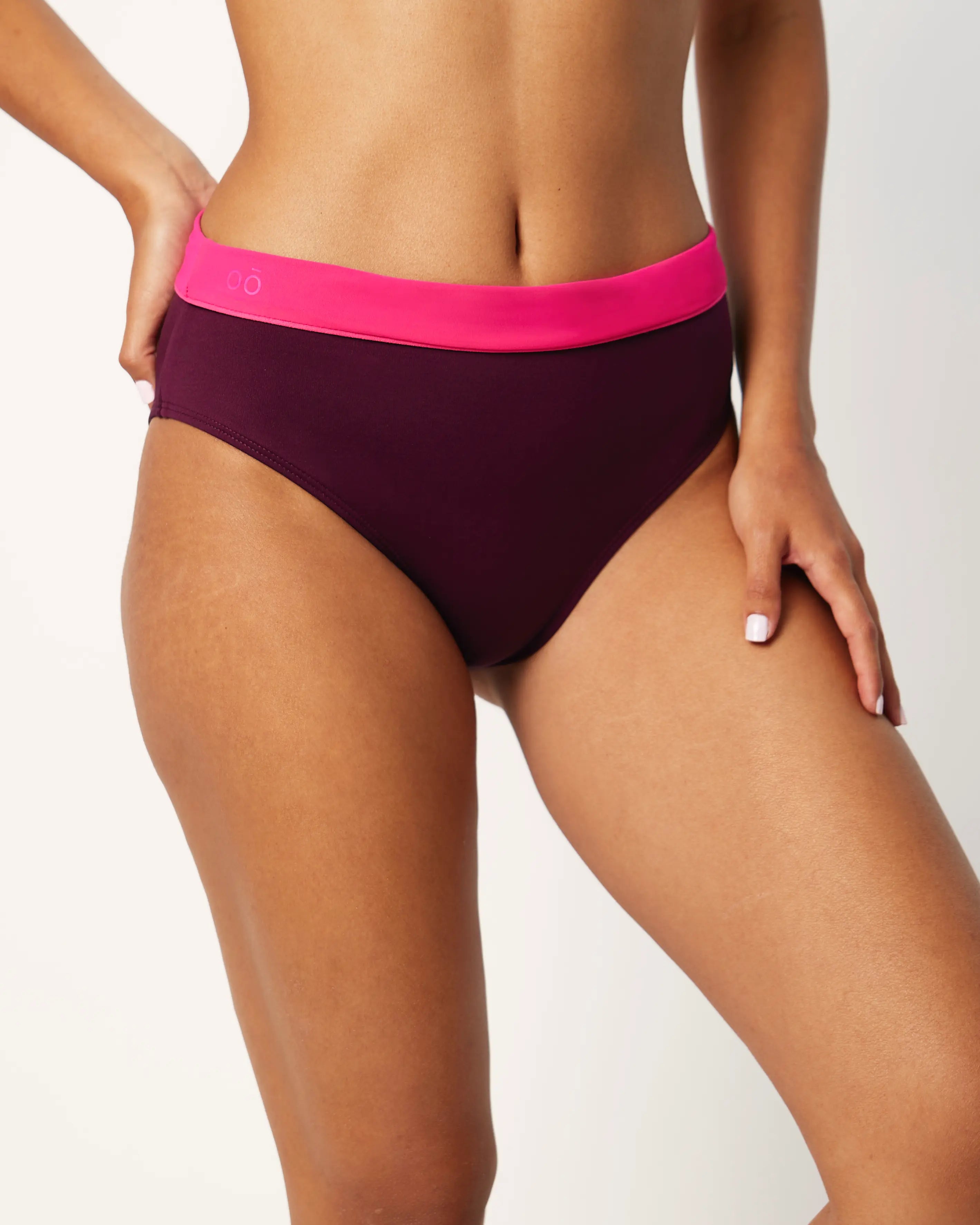 Ikonō La Versatile bikini swimsuit in Aubergine with high-waisted, foldable bottom. Designed for comfort and support, made from eco-friendly materials. Perfect for all body types, including post-surgery swimwear needs. A stylish and inclusive swimwear choice. #BeWhatMovesYou