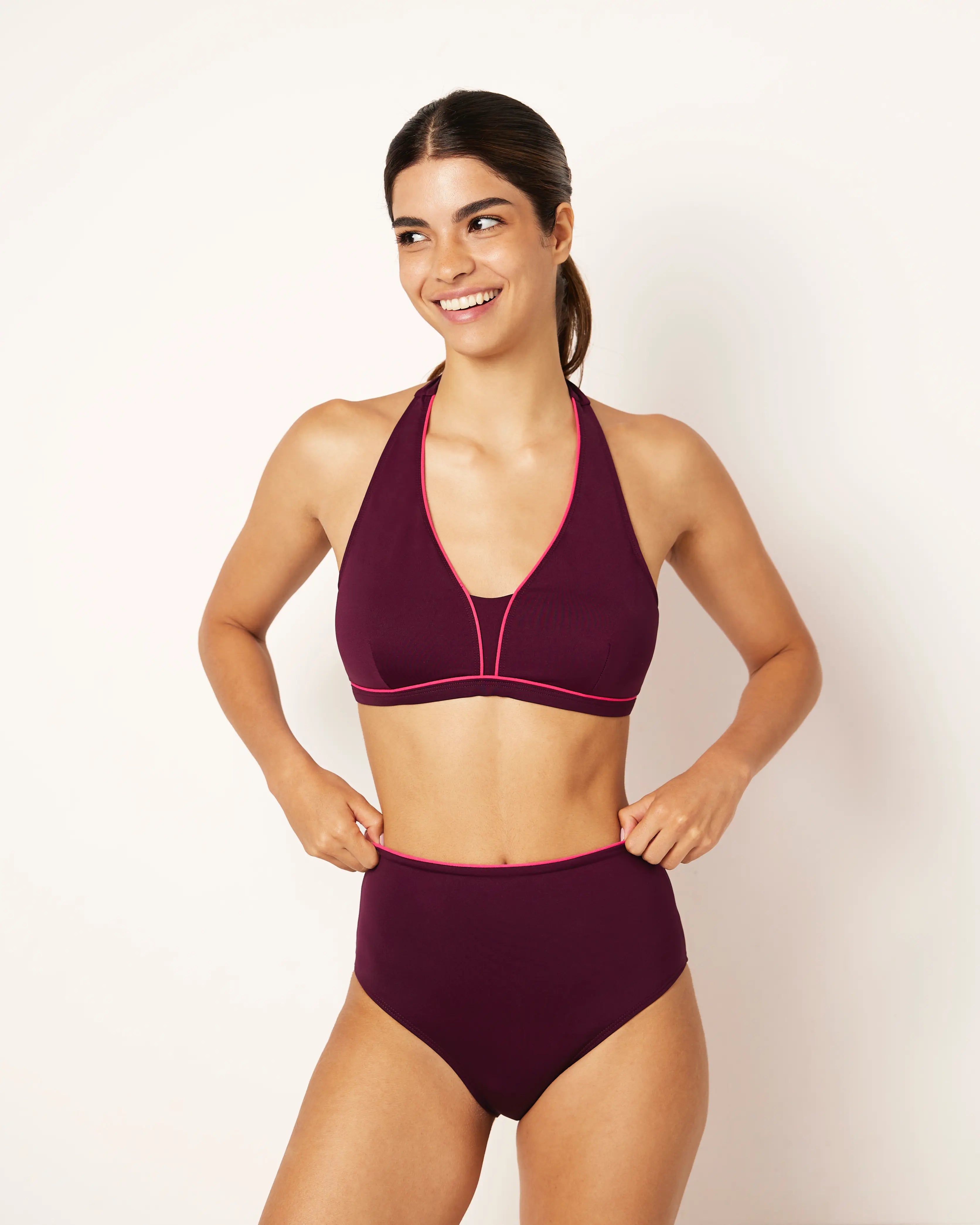Ikonō La Versatile bikini swimsuit in Aubergine with high-waisted, foldable bottom, supportive bra, and secret pocket for optional prosthesis. Designed for comfort and support, made from eco-friendly materials. Perfect for all body types, including post-surgery swimwear needs. A stylish and inclusive swimwear choice. #BeWhatMovesYou