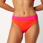 Ikonō La Versatile bikini swimsuit in orange with high-waist bottom. Designed for comfort and support, made from eco-friendly materials. Perfect for all body types, including post-surgery swimwear needs. A stylish and inclusive swimwear choice. #BeWhatMovesYou