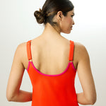 Back view of the model wearing the orange Ikonō tankini with adjustable shoulder straps, designed for comfort and inclusivity. Ideal for all body types including post-mastectomy.